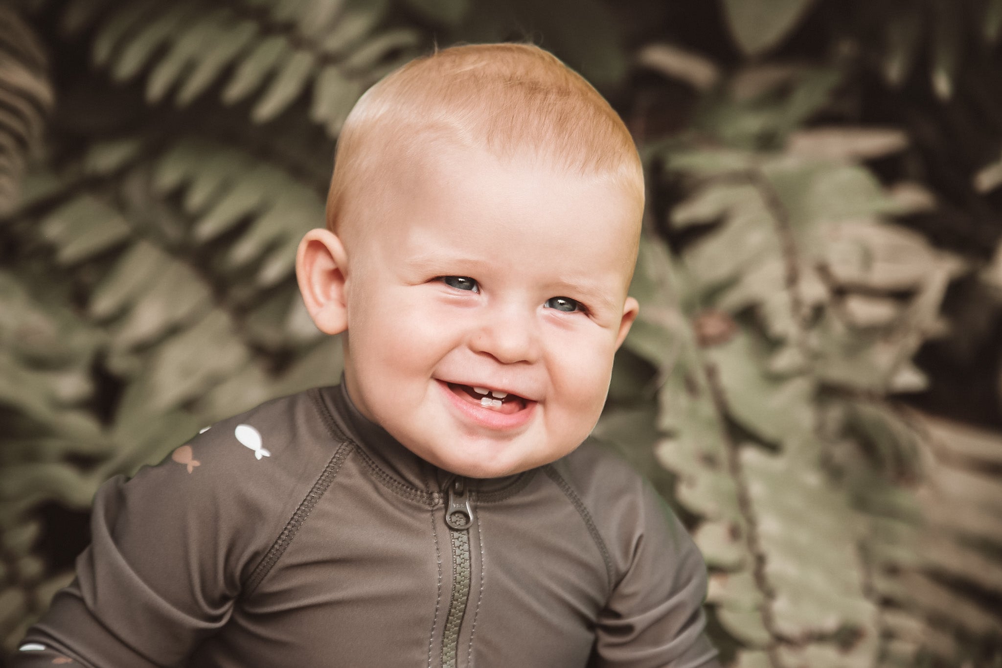 Baby wearing KidORCA swim jumpsuit and rash guard on the beach