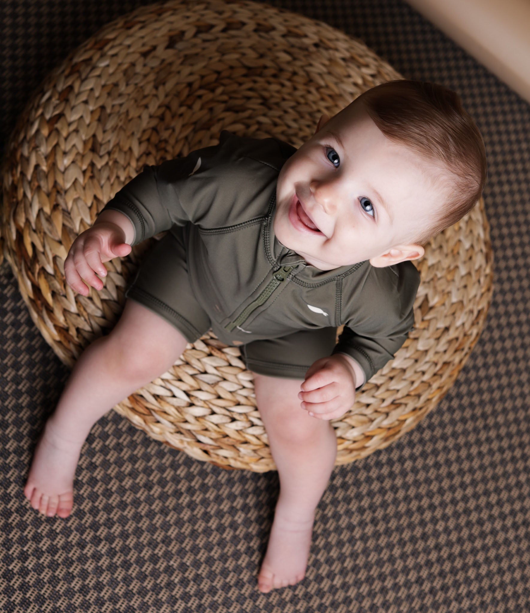 Baby playing in Trout Kalamata swim jumpsuit by KidORCA