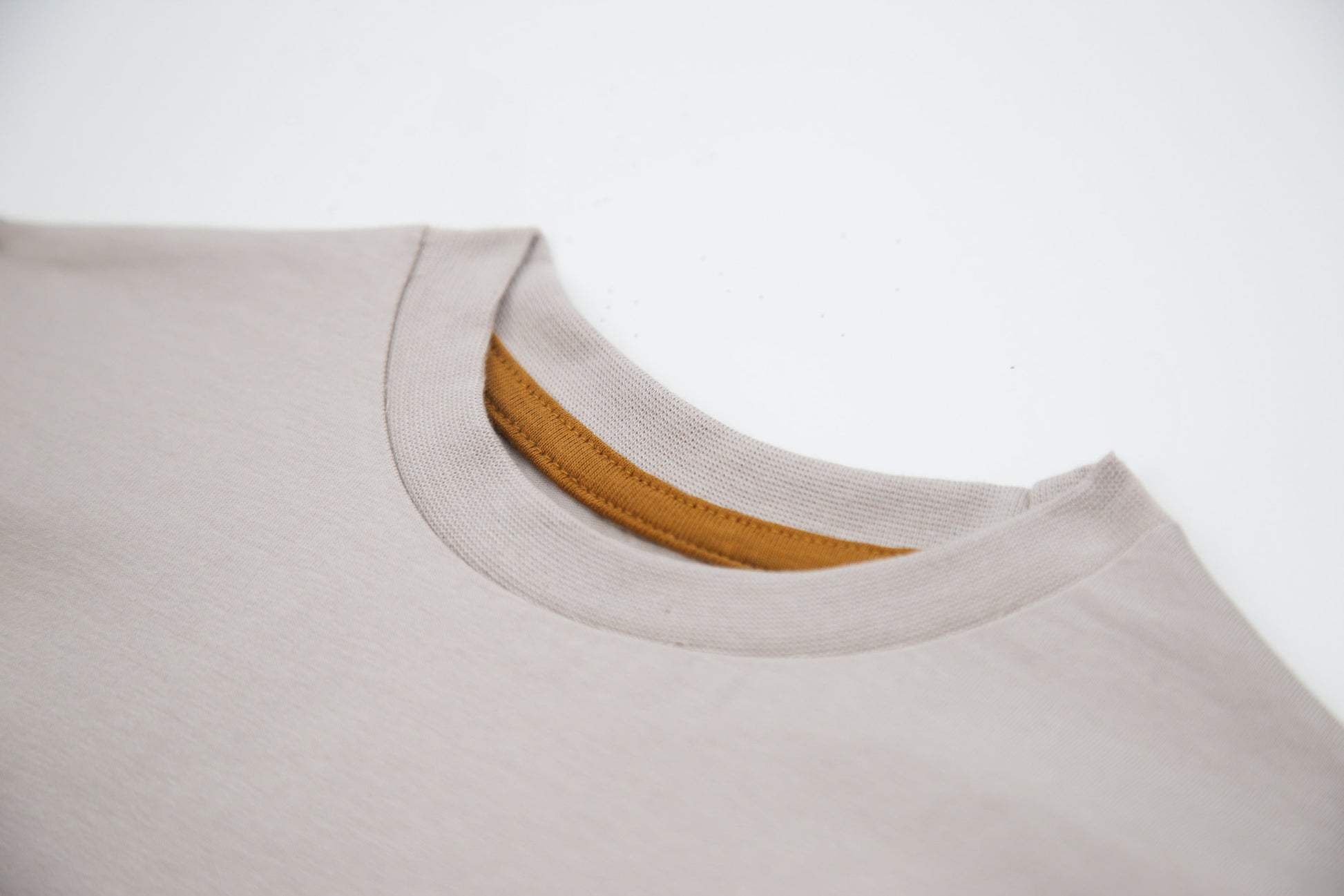Close-up of organic cotton fabric and crew neckline – dove kids tee