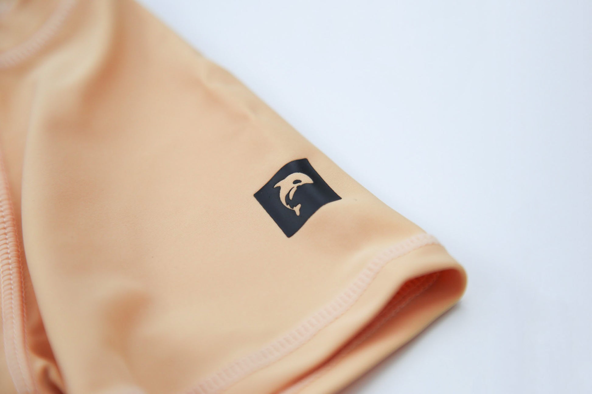 Close-up of UPF 50+ quick-dry recycled polyester – desert sand rashguard