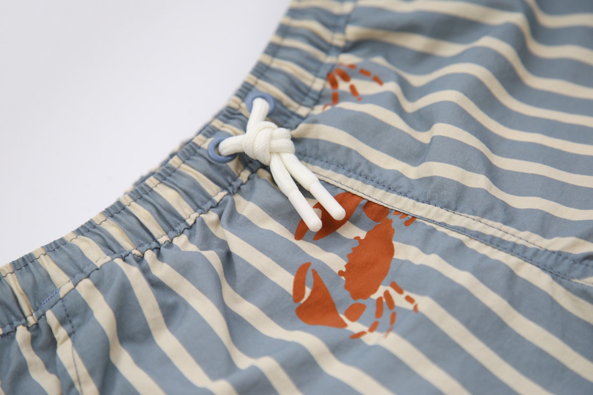 Elastic waistband detail on crab slate boys swim trunks