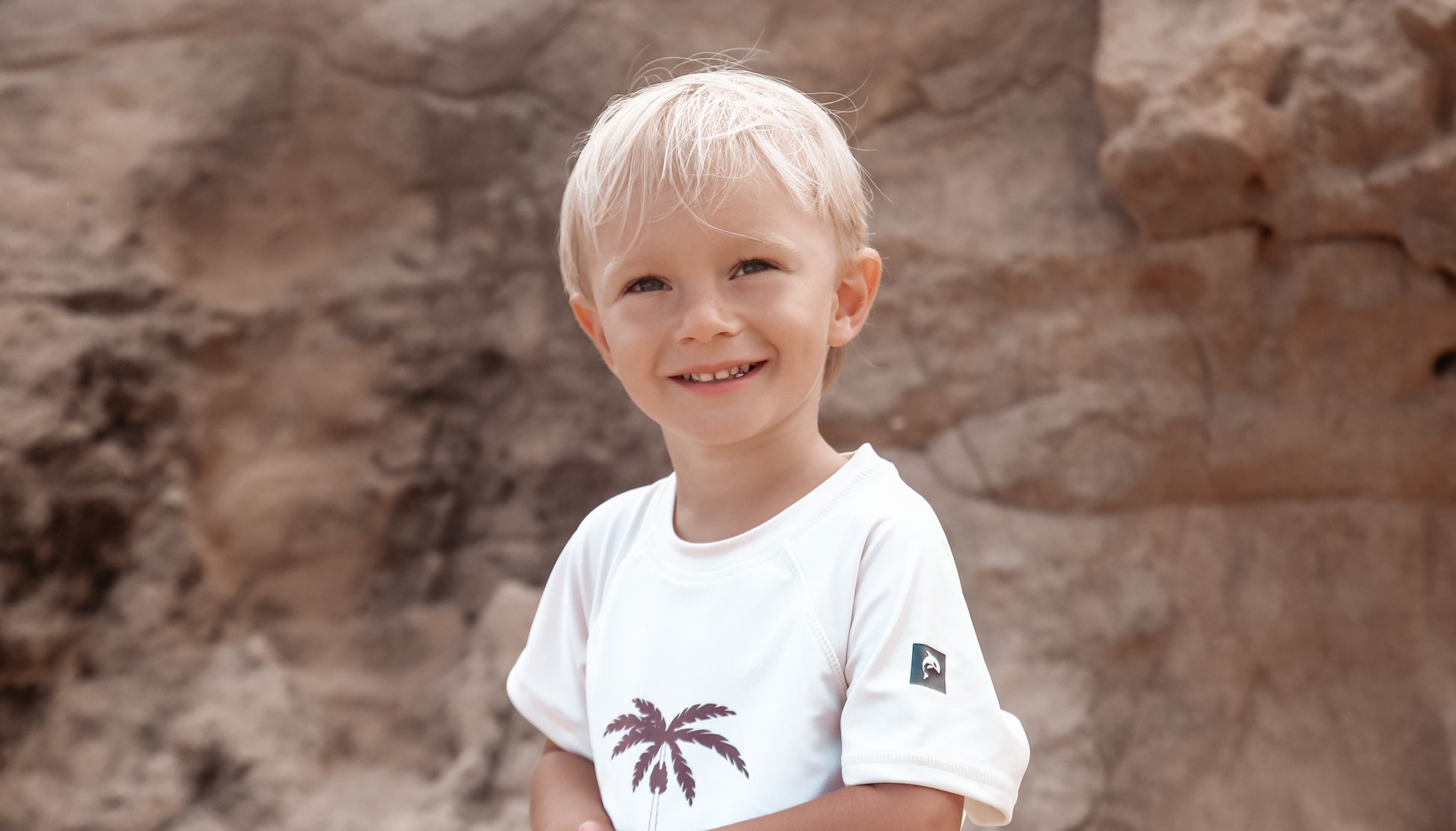 Child playing in palm tree rashguard by KidORCA