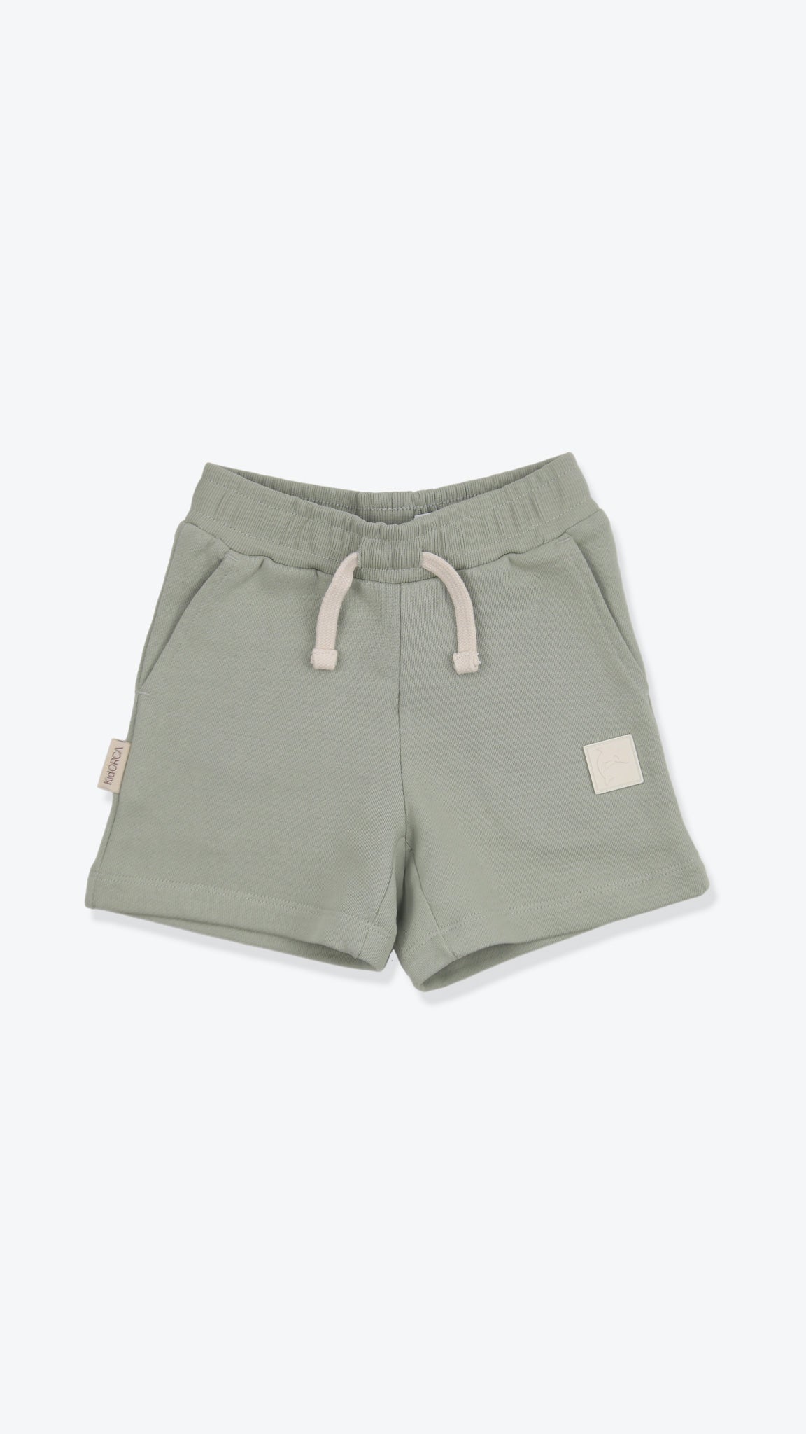 Organic french terry kids shorts in sage green – front view