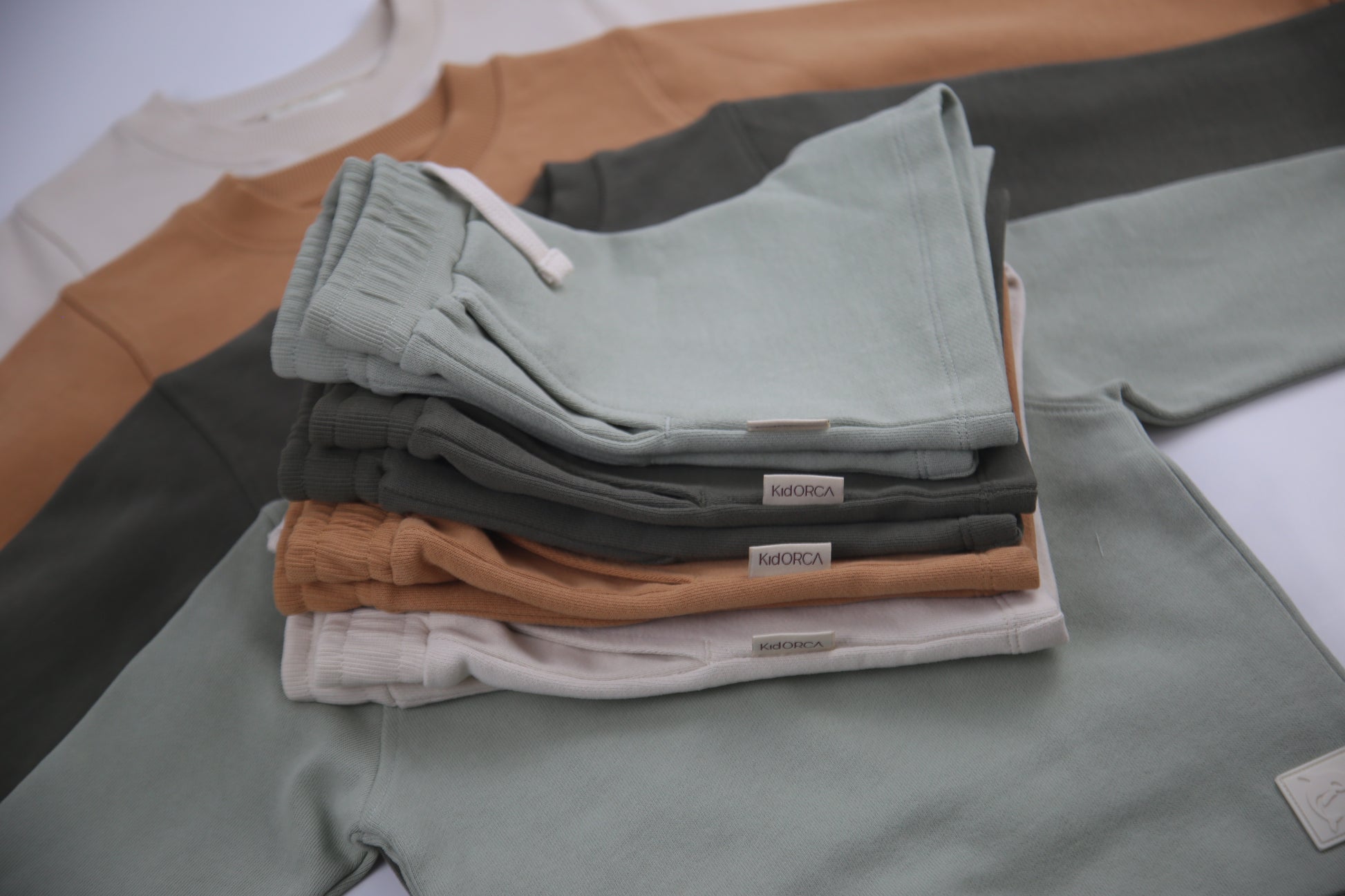 Hem and seam detail on sage green french terry kids shorts