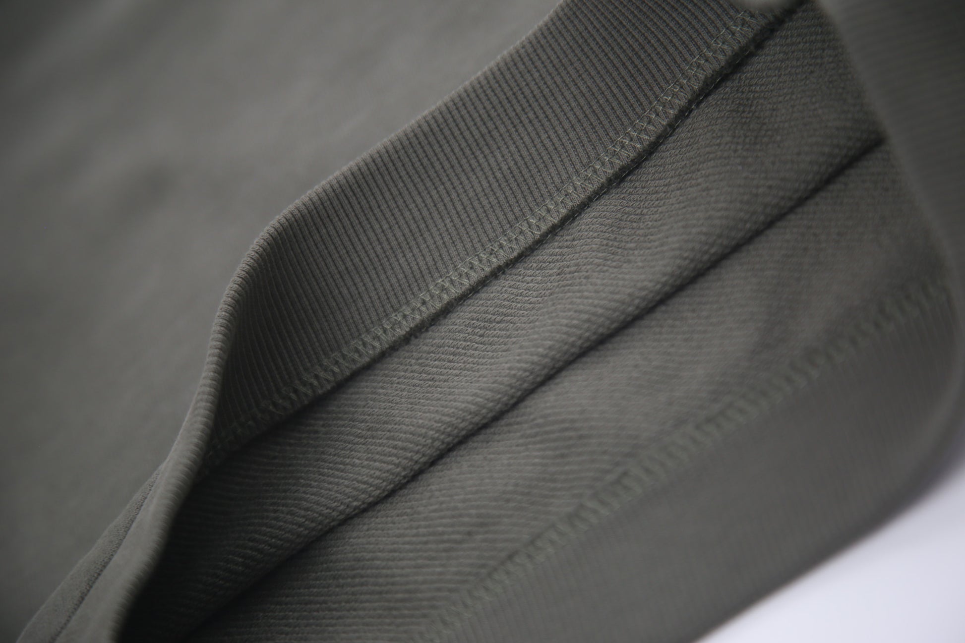 Hem and seam detail on dusty olive french terry kids shorts