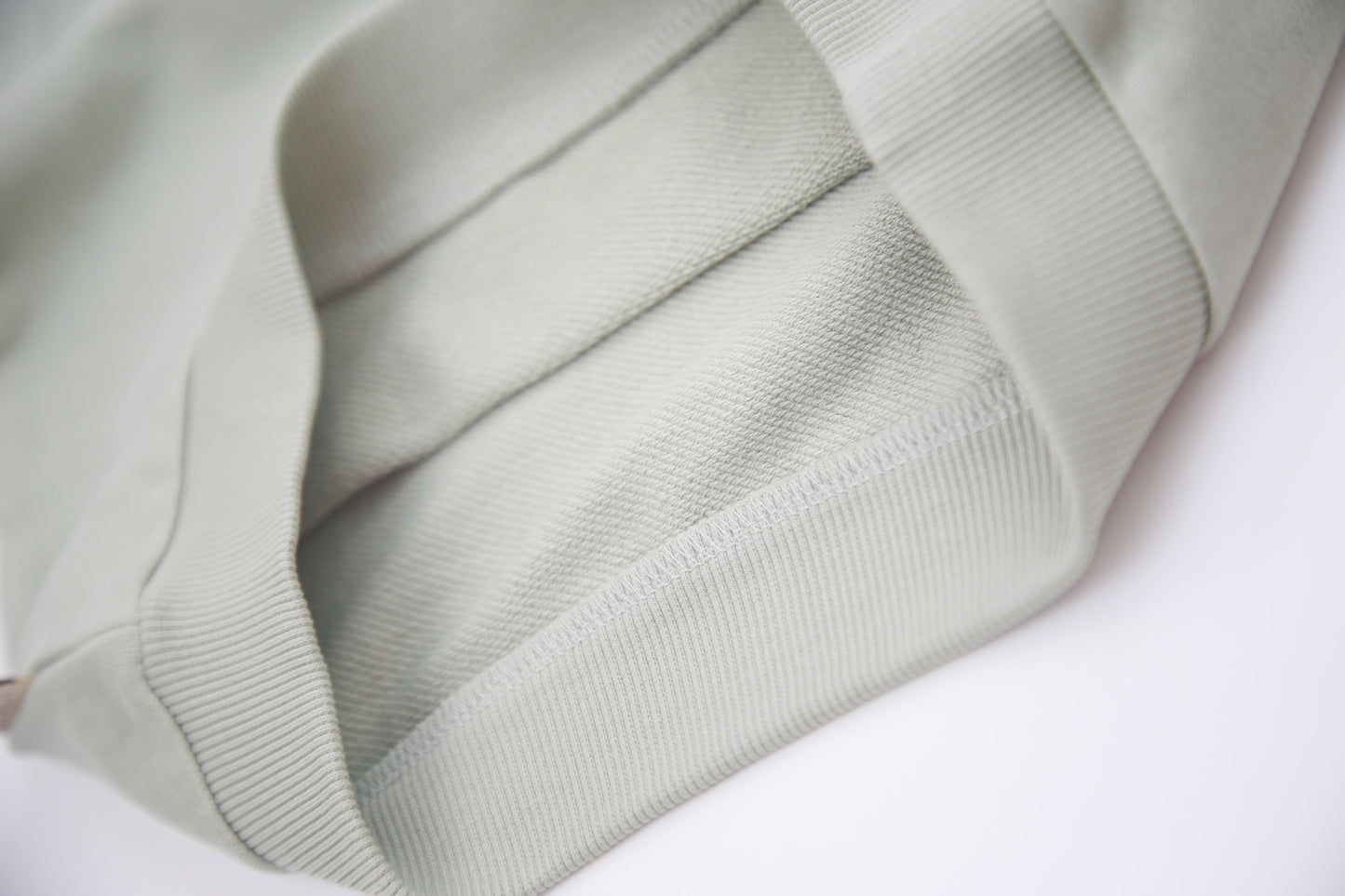 Close-up of organic french terry fabric texture – sage kids shorts