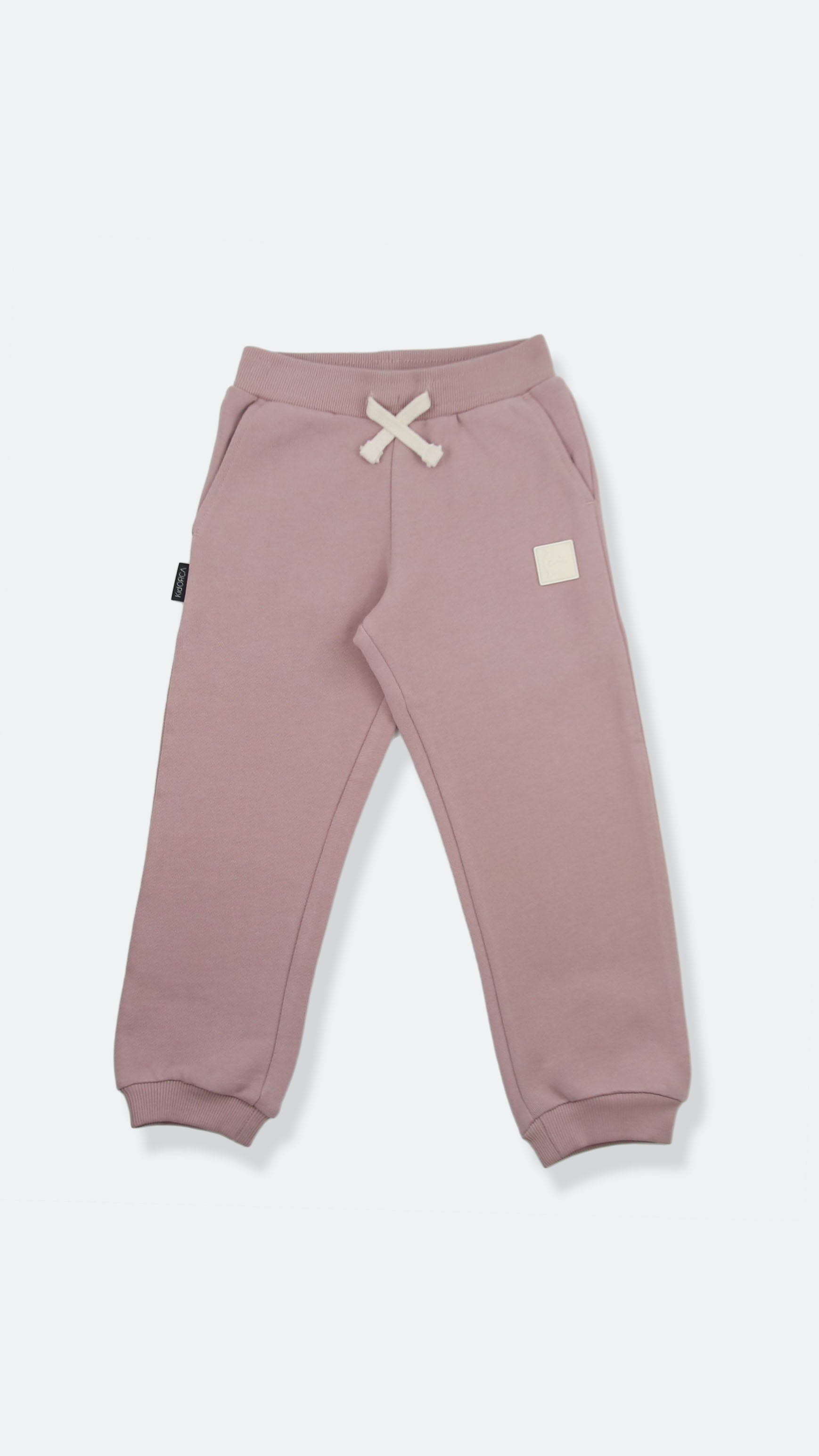 Organic french terry kids sweatpants in mauve color – front view