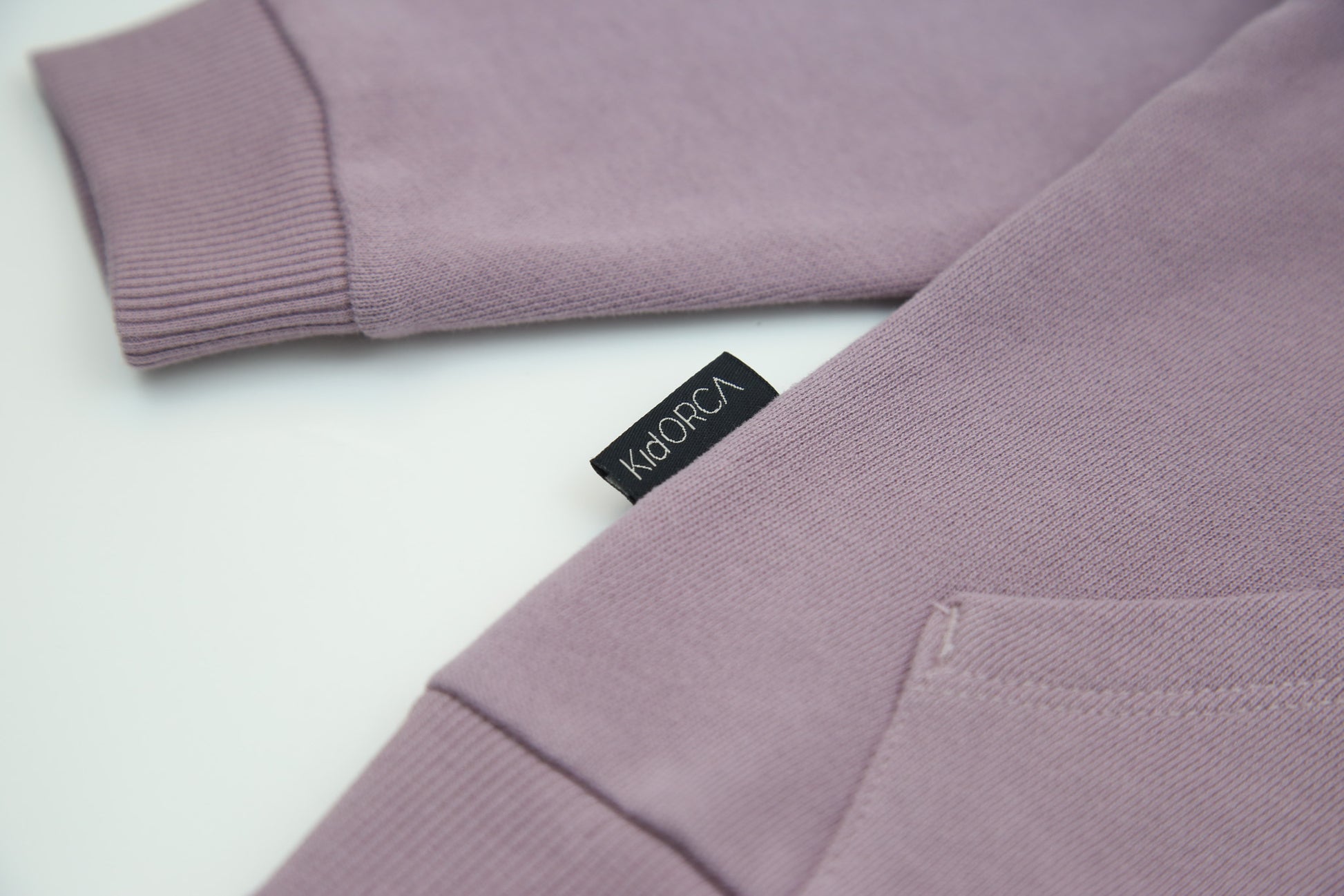 Rib cuff and hem detail on elderberry french terry kids sweatshirt