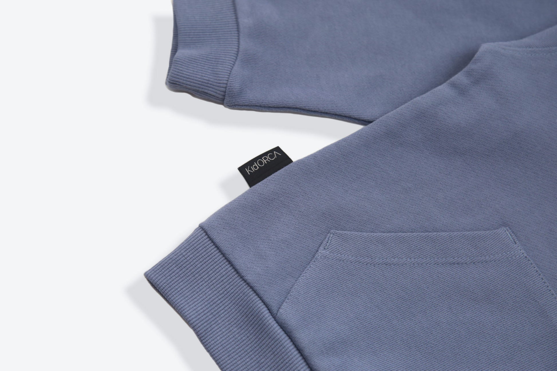 Kangaroo pocket and rib cuff detail on flint french terry kids hoodie