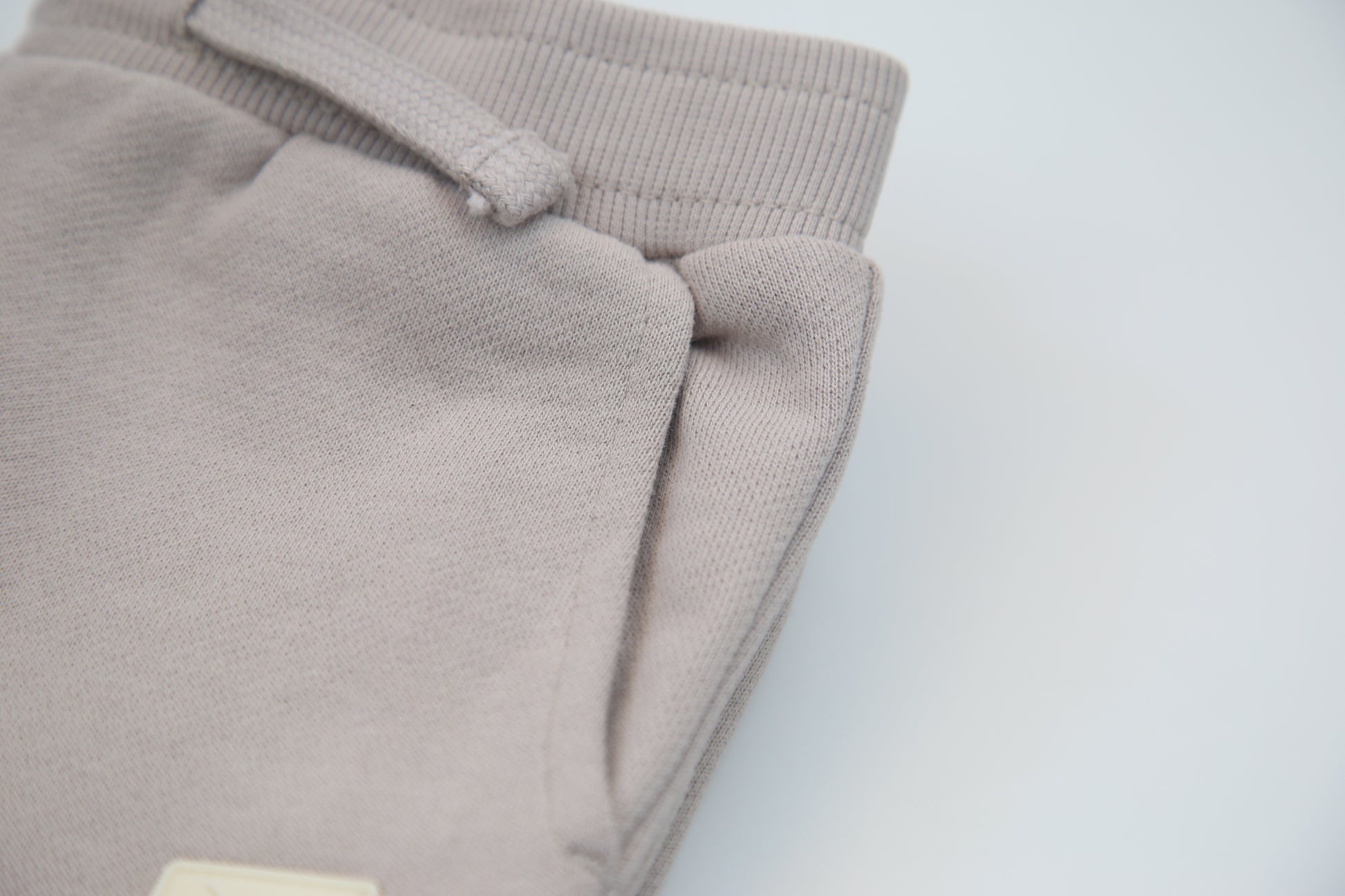 Rib cuff and side pocket detail on dove brushed terry kids sweatpants