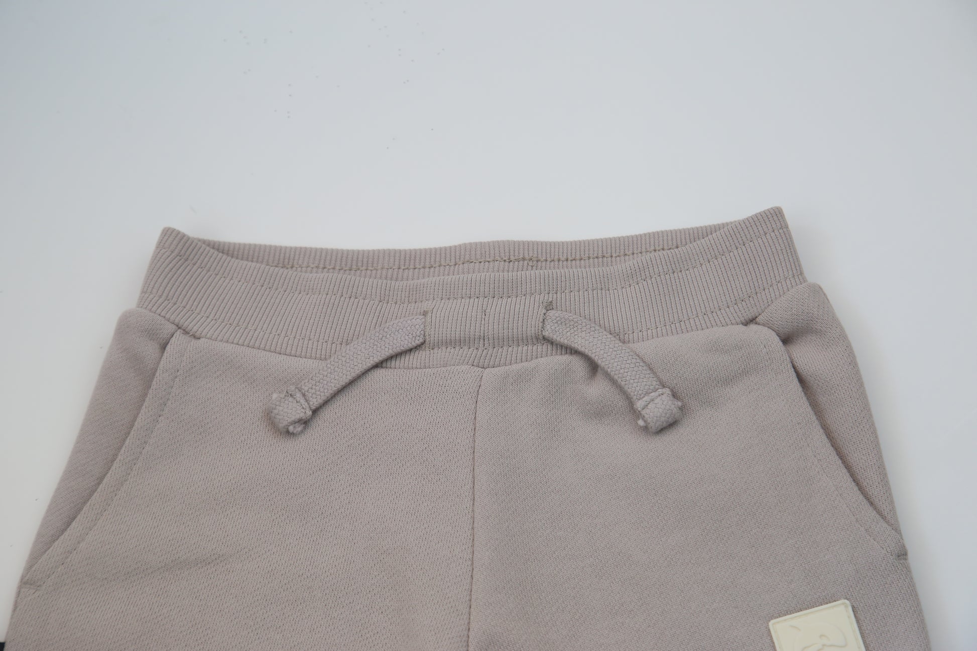 Rib cuff and side pocket detail on dove brushed terry kids sweatpants