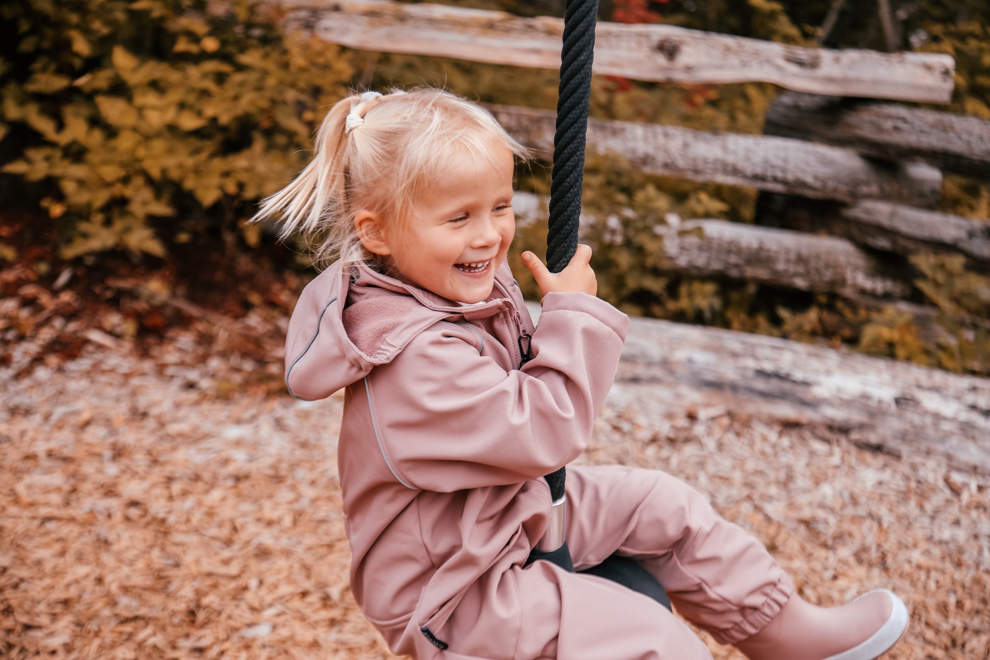 Child wearing ash-rose softshell overall by KidORCA