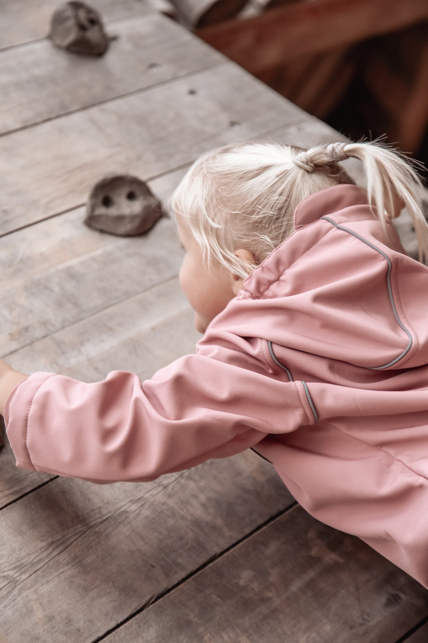 Child wearing ash-rose softshell overall by KidORCA