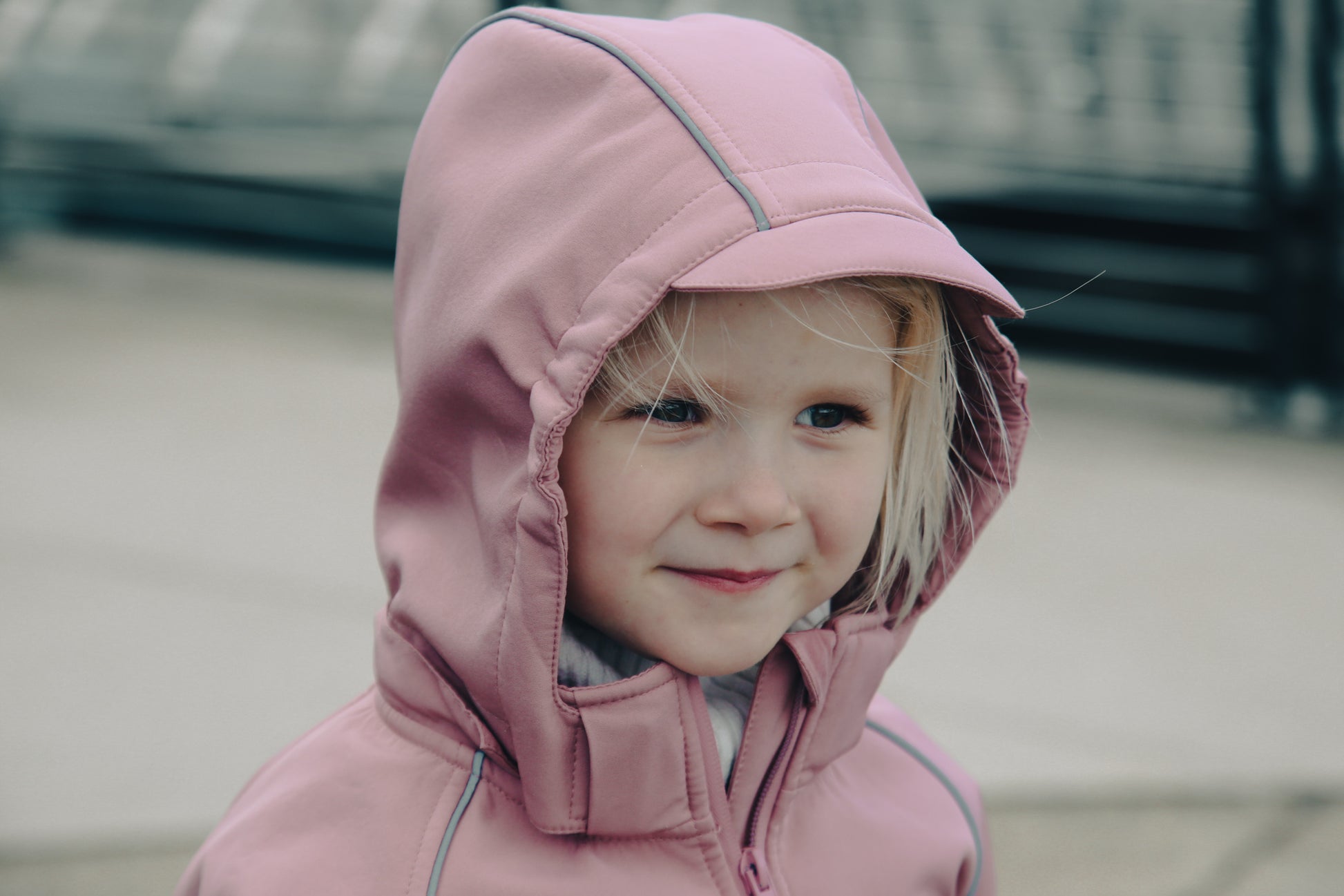 Child wearing ash-rose softshell overall by KidORCA