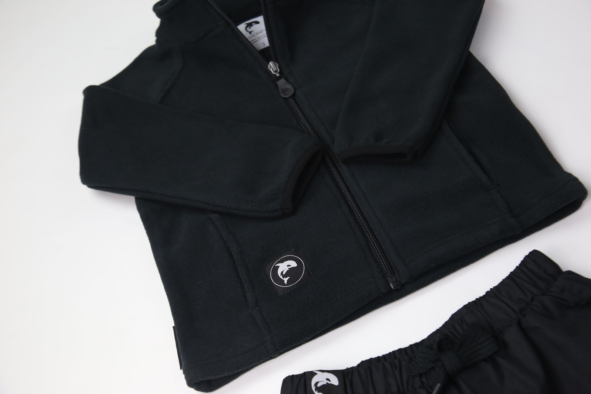 Close-up of soft black fleece fabric – kids jacket