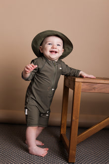 Baby wearing Trout Kalamata jumpsuit – side view with high collar