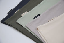 Close-up of organic cotton fabric texture – oat beige kids tee