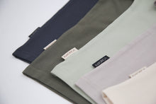 Close-up of organic cotton fabric on dusty olive kids tee