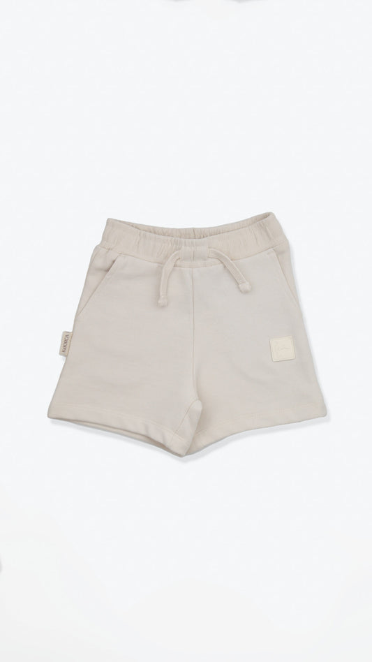Organic french terry kids shorts in oat color – front view