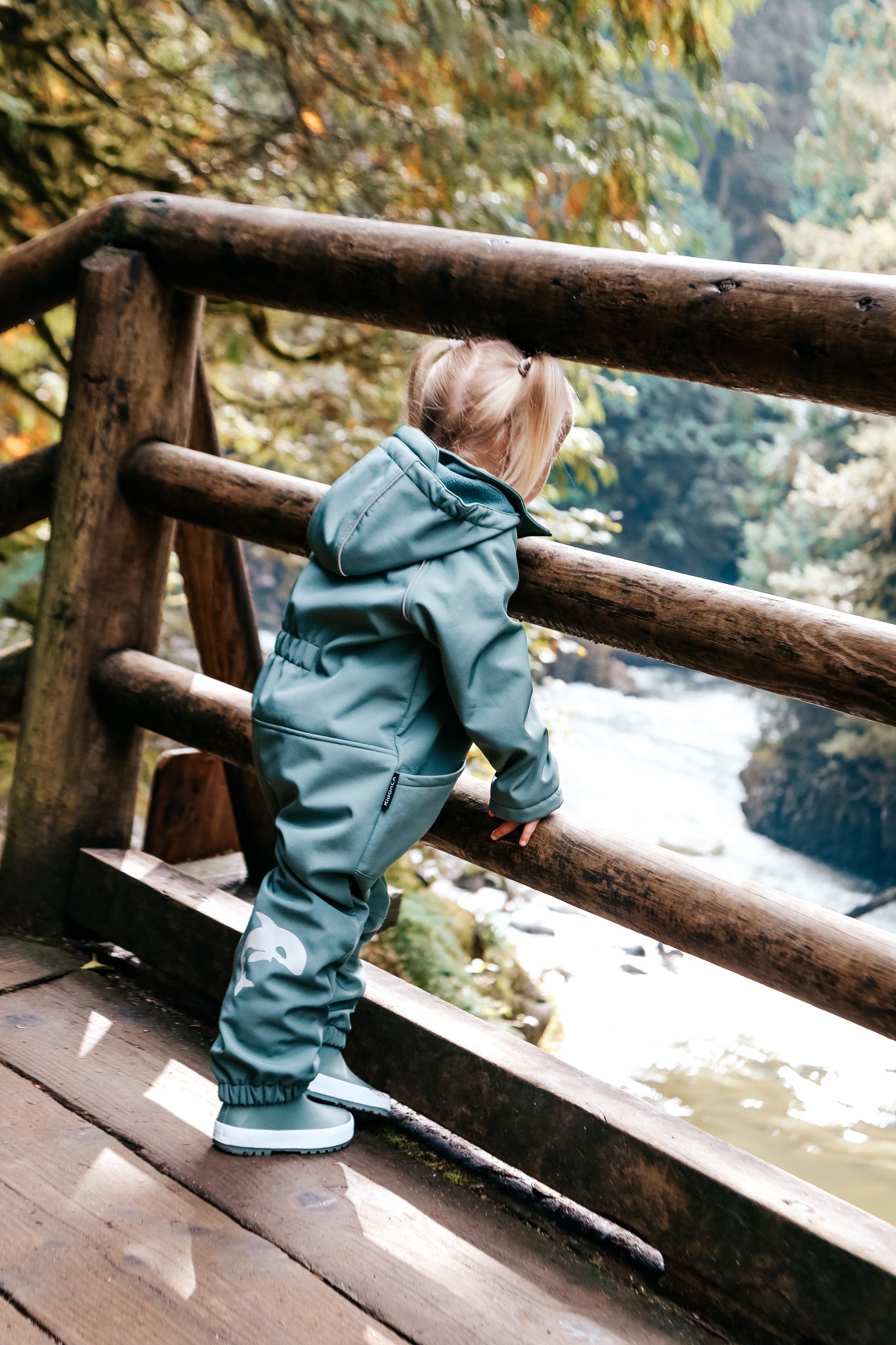 Child wearing olive play suit by KidORCA